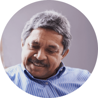 Man in a yellow shirt talking on the phone, headshot